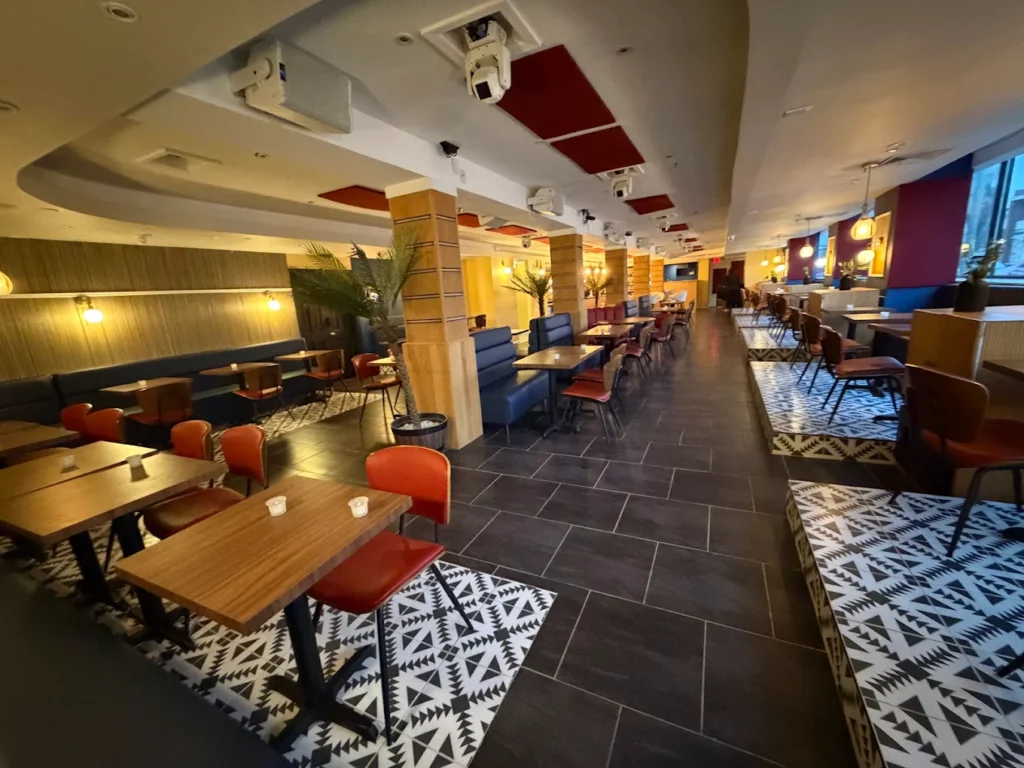 Spacious dining room with geometric tile floors and colorful Caribbean decor