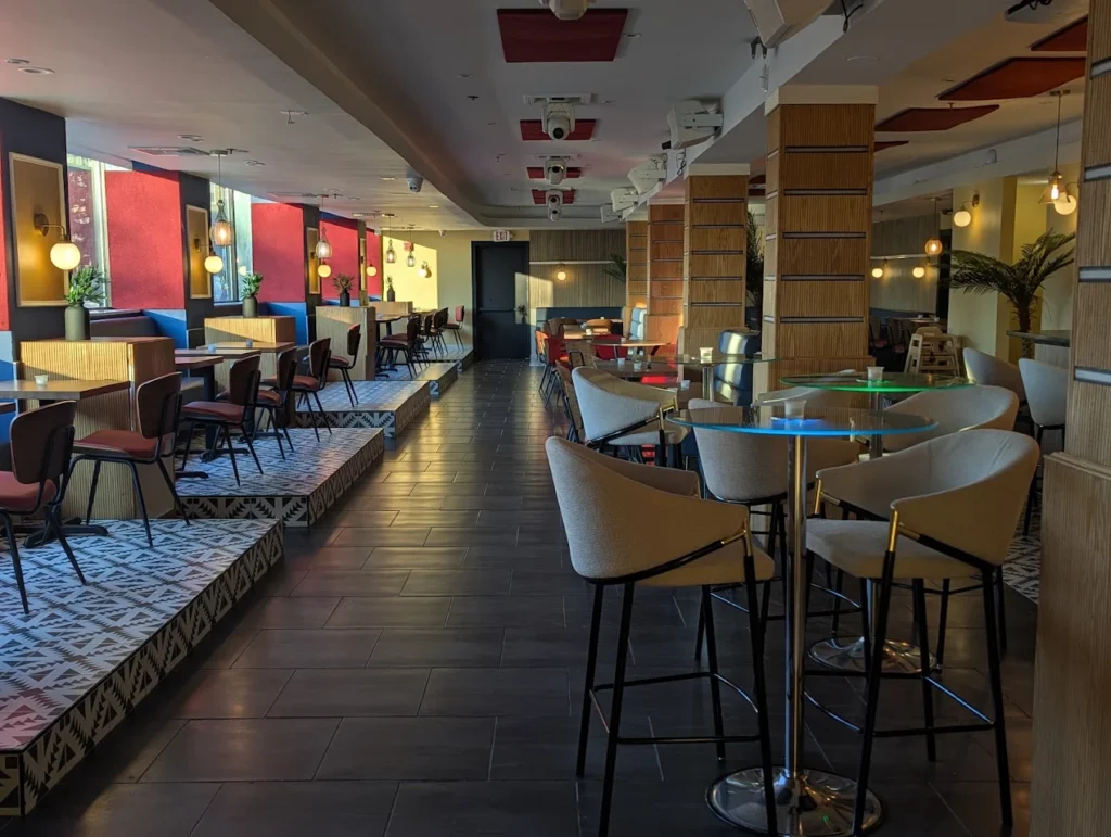 Stylish interior of Champion Caribbean Restaurant and Lounge with warm lighting and modern seating